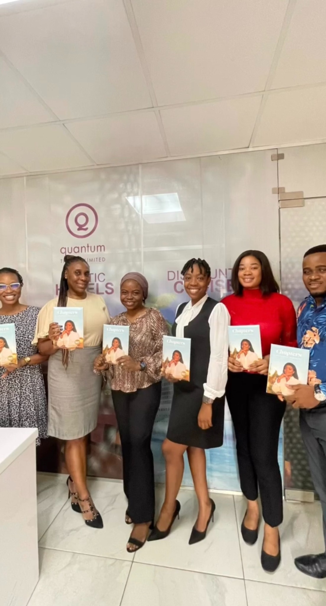 Quantum Travels team holding CHAPTERS books.